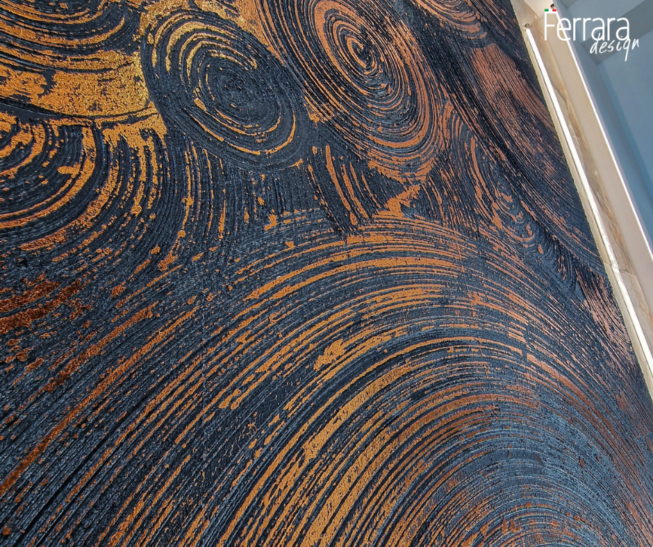 Close-up of a textured surface with swirling patterns in blue and brown, featuring the brand 'Ferrara Design'.