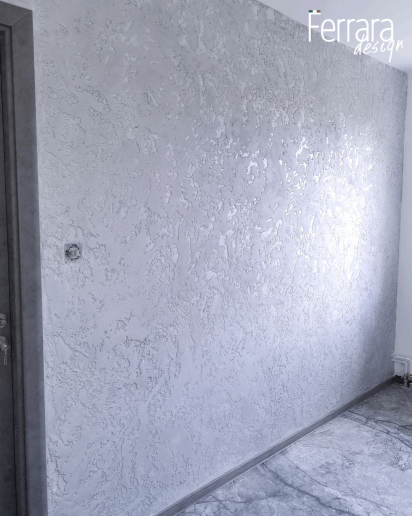 Textured gray wall with 'Ferrara Design' branding