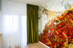 Colorful wall mural with gold, red, and black abstract design in interior decor