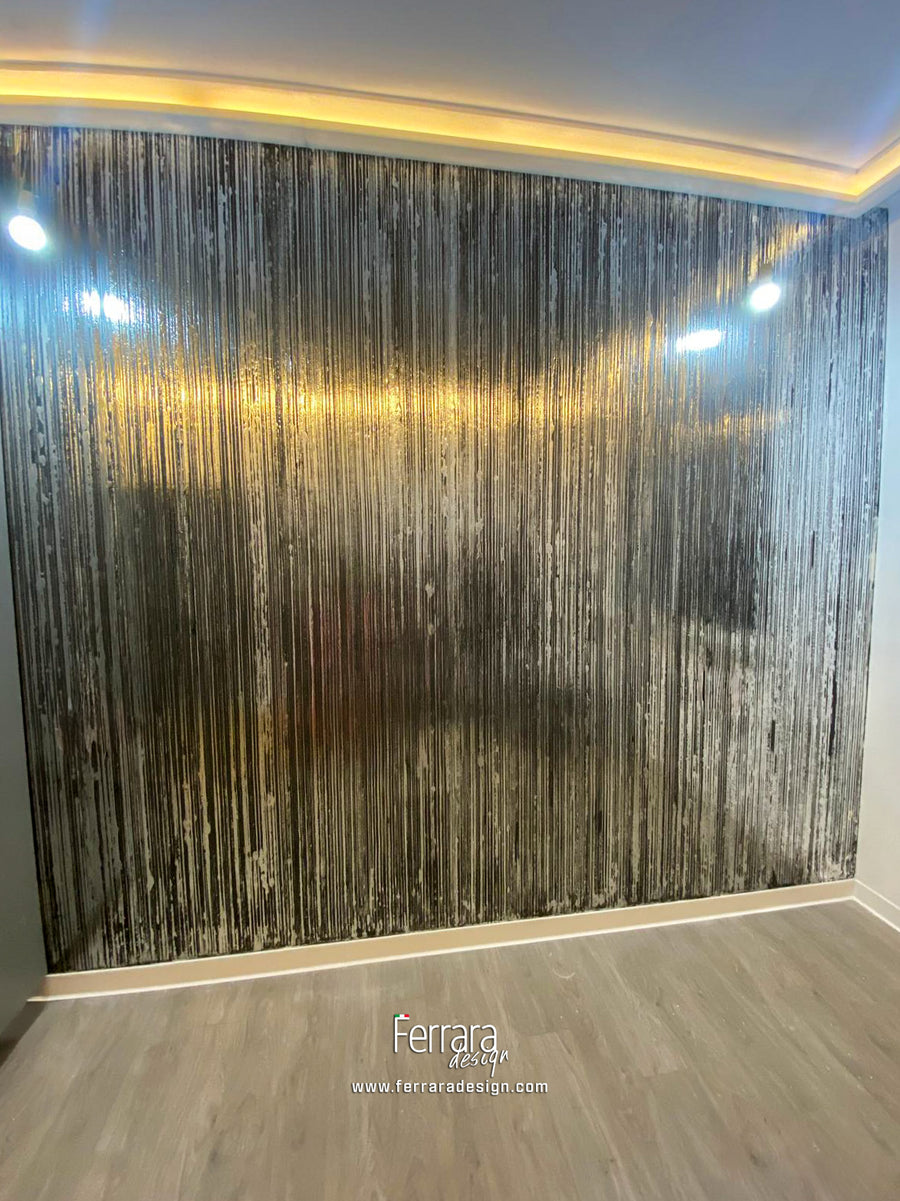 A large wall texture wall or wall featuring a vertical metallic silver and black distressed wood-grain pattern, installed on a wall in a room with light wood flooring and white walls.