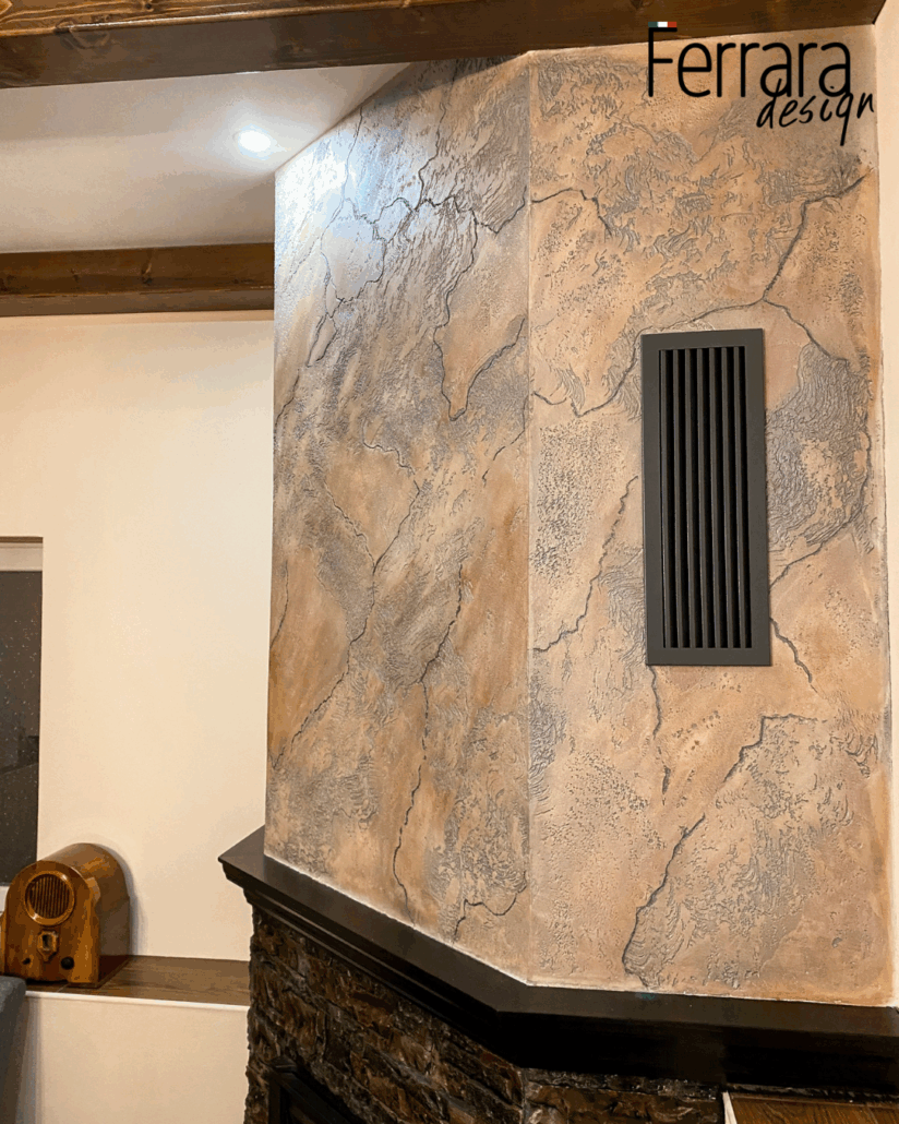 Stylish stone wall with decorative vent and 'Ferrara Design' branding.