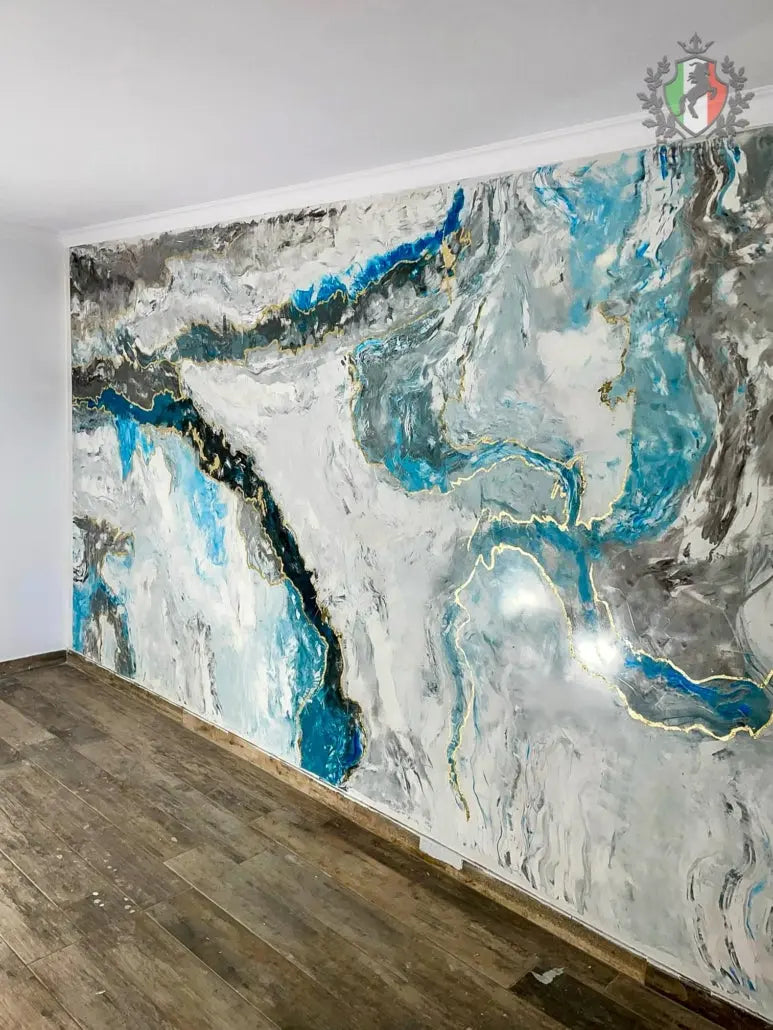 Abstract wall art with blue and gray colors on a white wall.