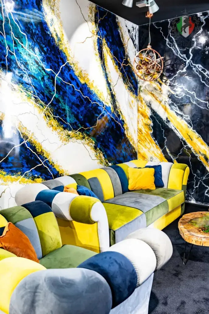 Colorful sofa against a marble-patterned wall with abstract art
