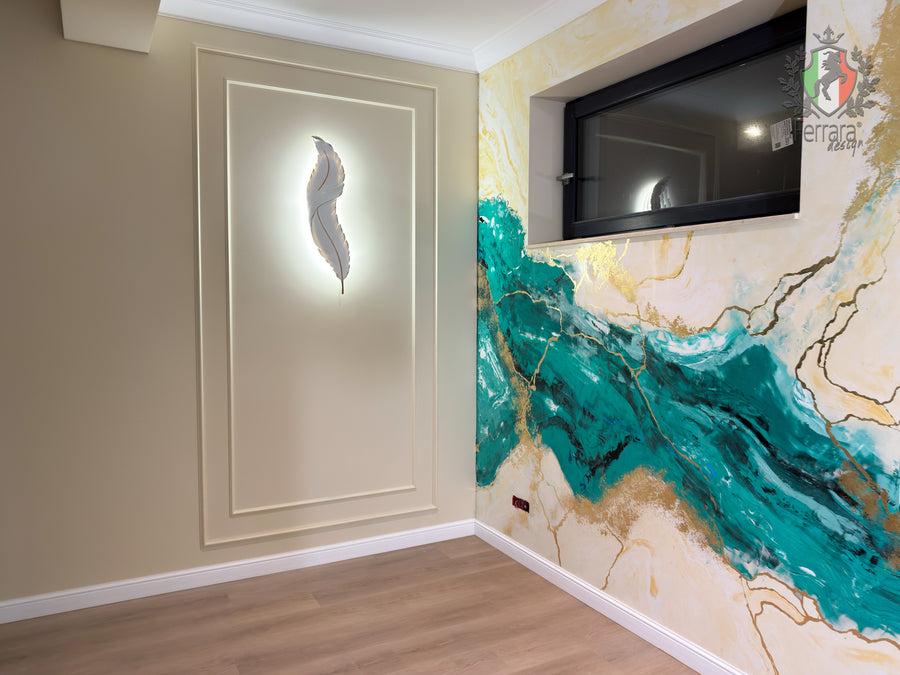 A modern interior room corner featuring a large abstract wall mural with teal, gold, and cream marble-like veining, alongside a recessed wall panel with a feather-shaped light fixture and a black-framed window.