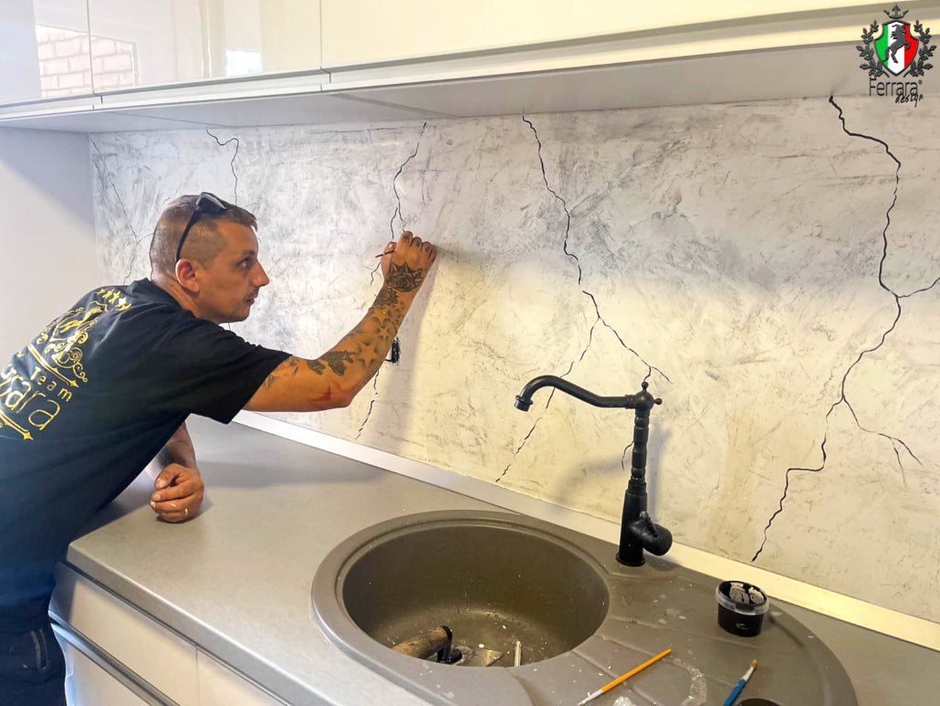 Person installing a backsplash in a kitchen
